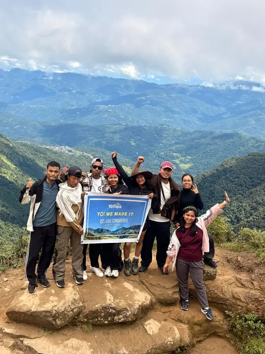 Crew celebrating on a hilltop